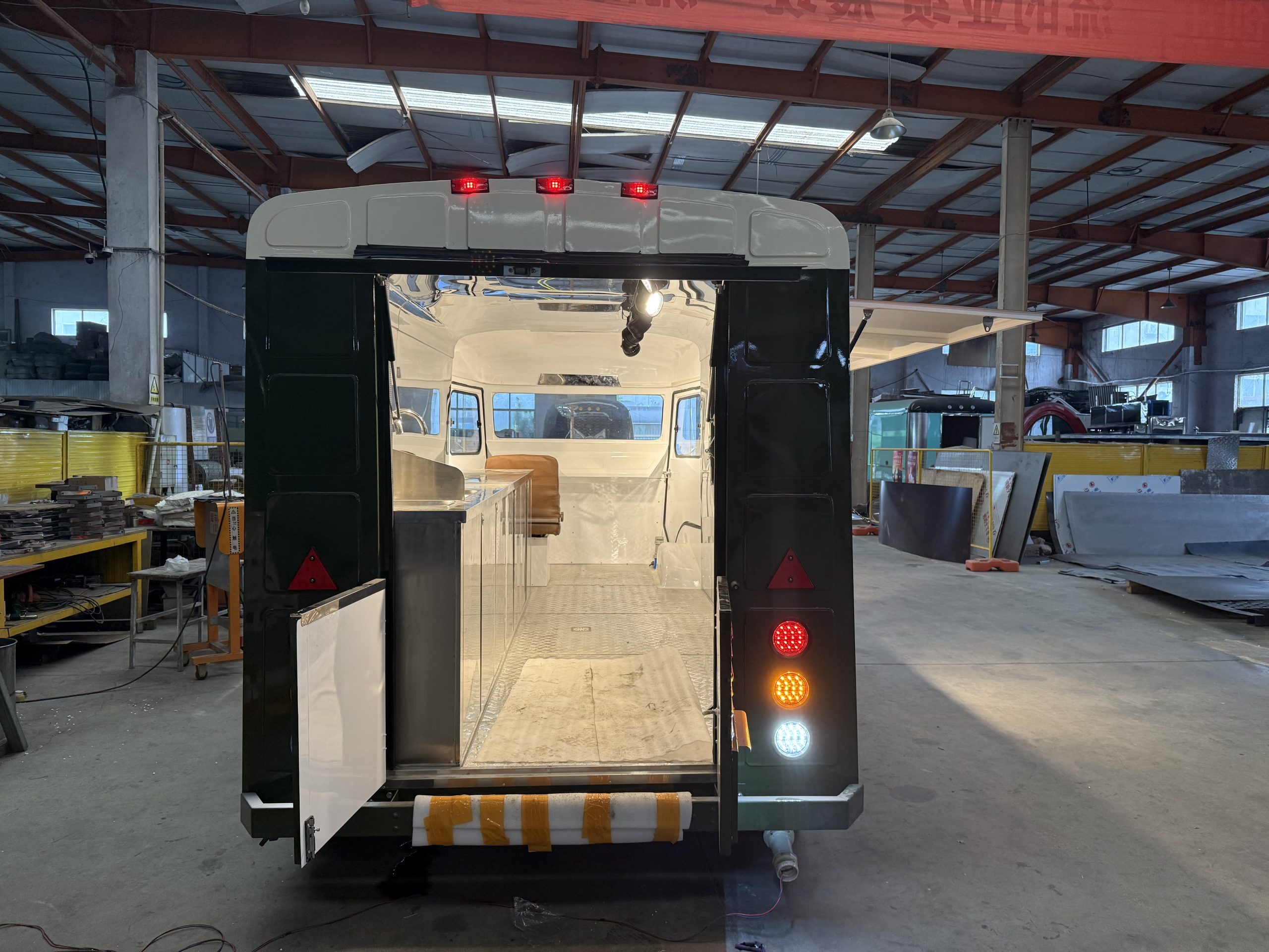 Rear entrance and stainless steel workspace inside retro food trailer