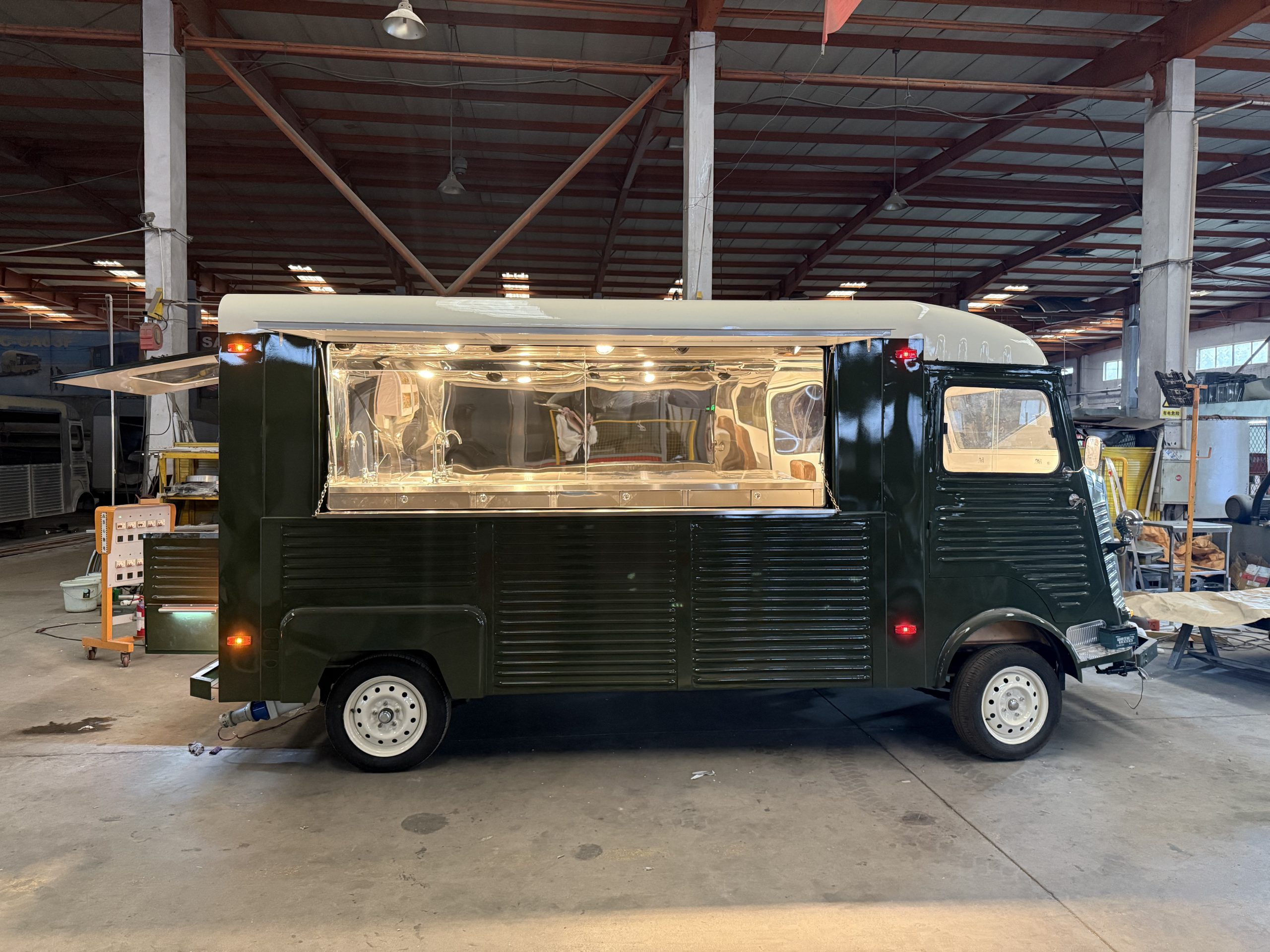 Side view of retro Citroën-style food trailer with large open serving window