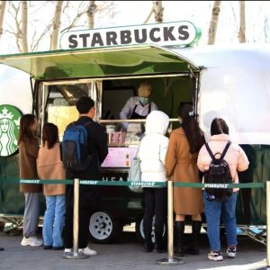 Starbucks style mobile coffee trailer serving customers outdoors