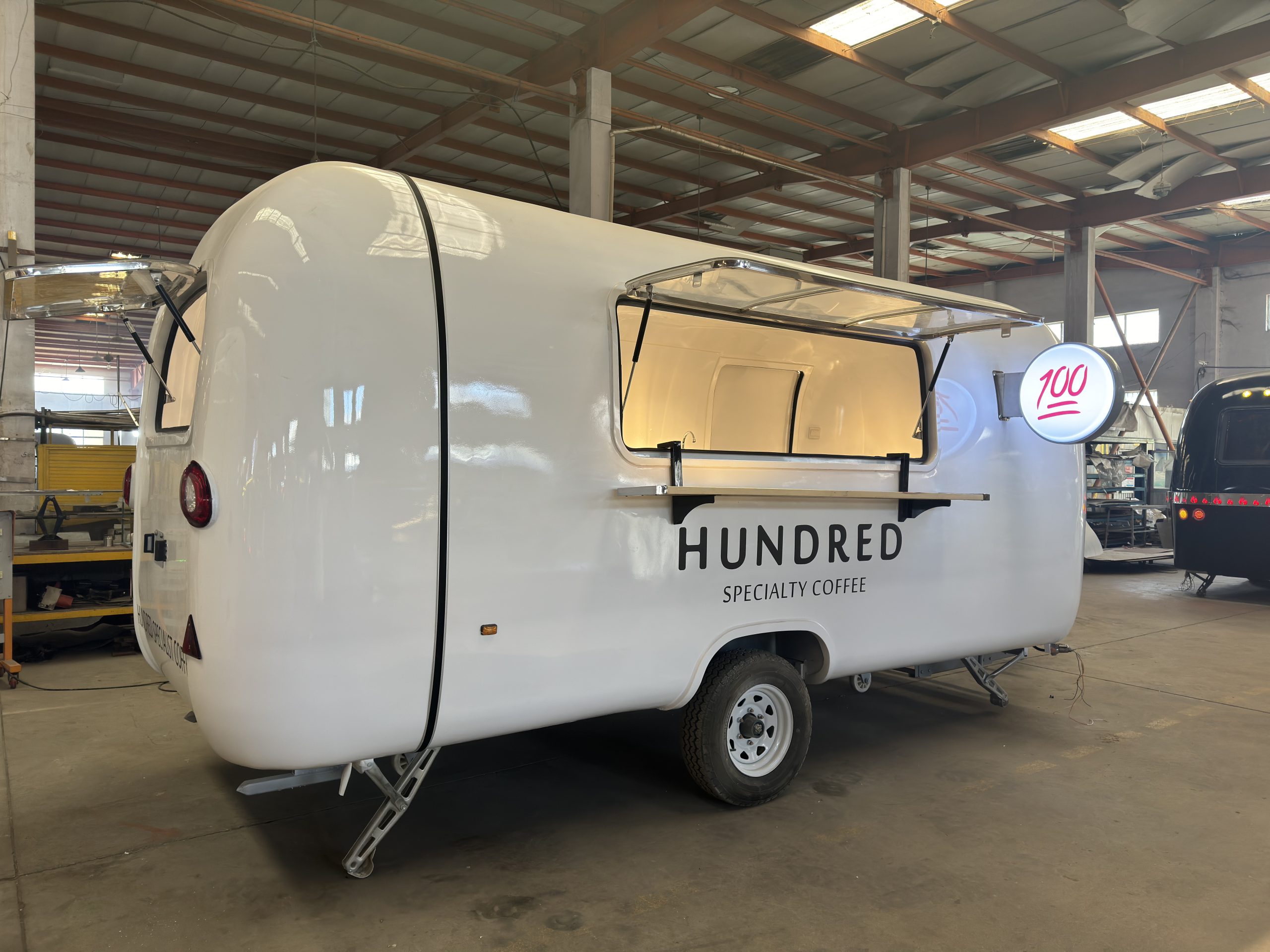 Custom specialty coffee trailer built for Qatar client with illuminated branding sign and serving window