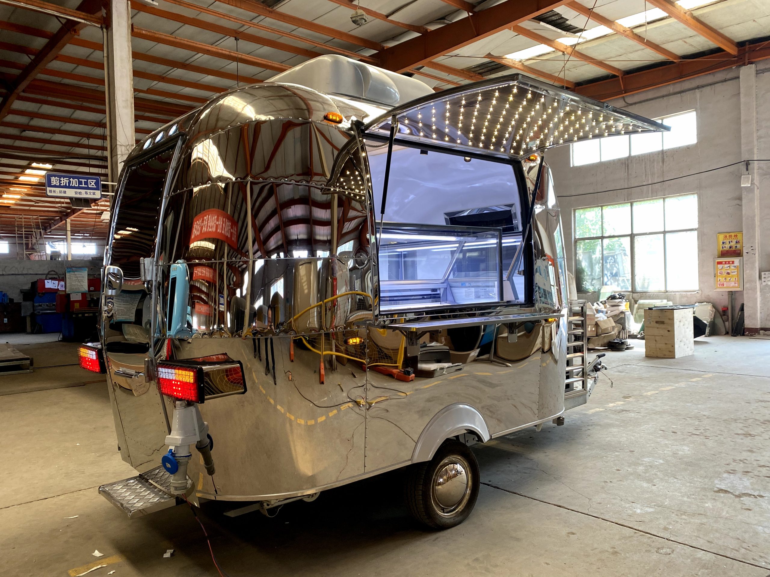 Mirror finish stainless steel ice cream food trailer with illuminated canopy