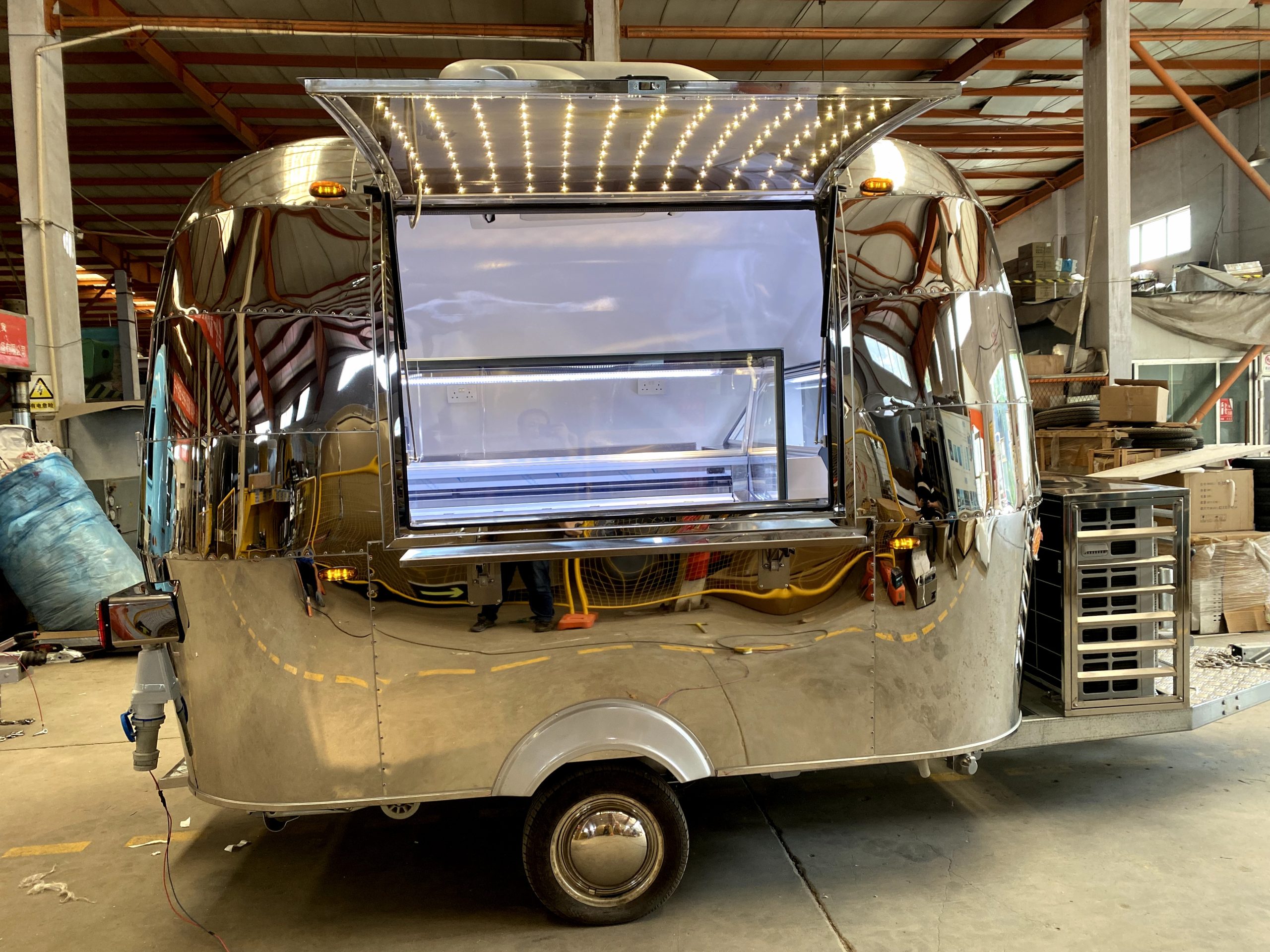 Mobile ice cream trailer with LED serving window and commercial display freezer