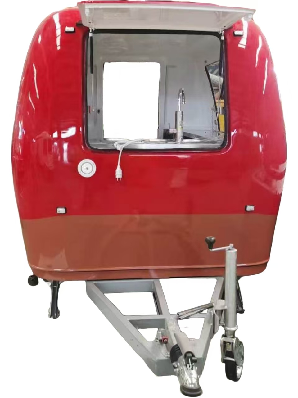 Front serving window of retro mini coffee trailer with stainless steel workspace